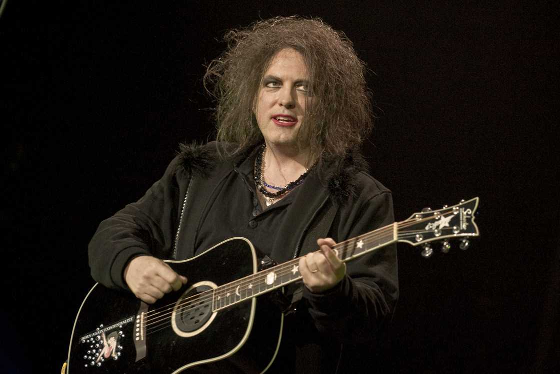 Robert Smith of The Cure playing the guitar at the O2 Arena in London