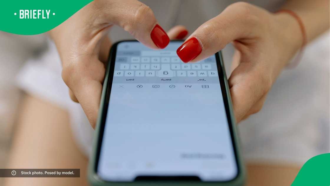 A woman typing on her phone.