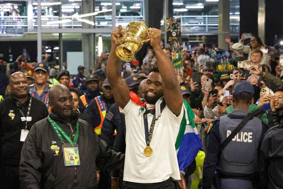Siya Kolisi celebrating his World Cup win by lifting the trophy high Siya Kolisi celebrating his World Cup win by lifting the trophy high