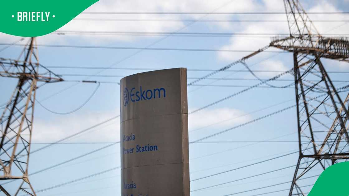 A sign for Eskom, the South African electricity authority, stands next to electricity pylons near Cape Town on January 22, 2023