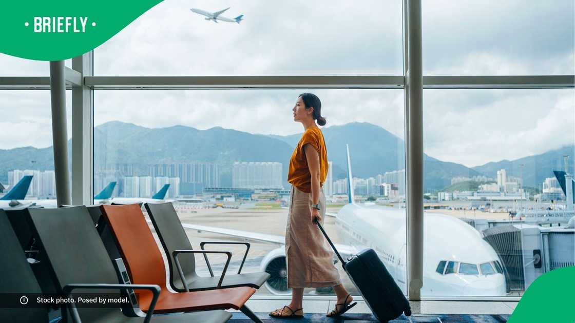 A woman with a suitcase at the airport.