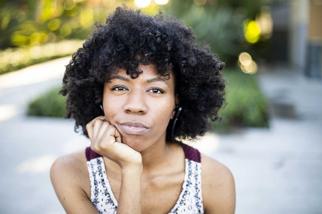 A young black woman thinking