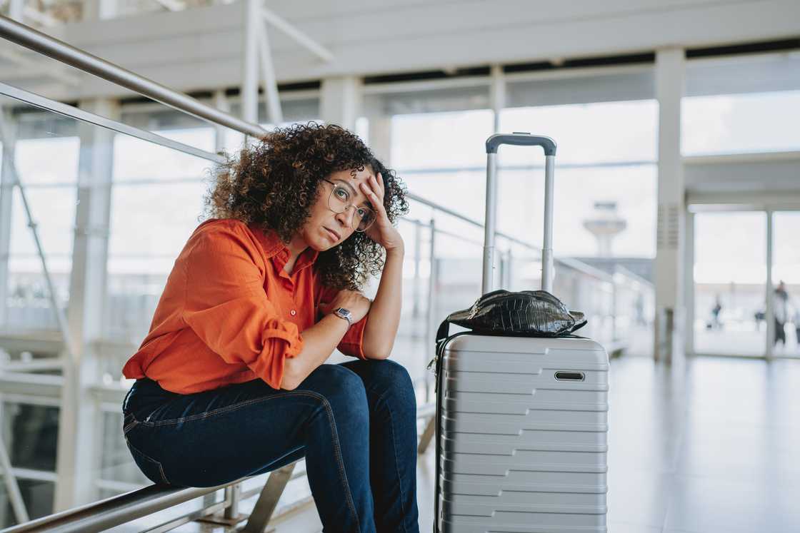 A tired woman with a suitcase