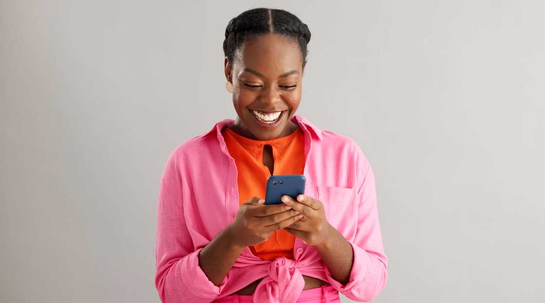 Woman smiling at her phone.