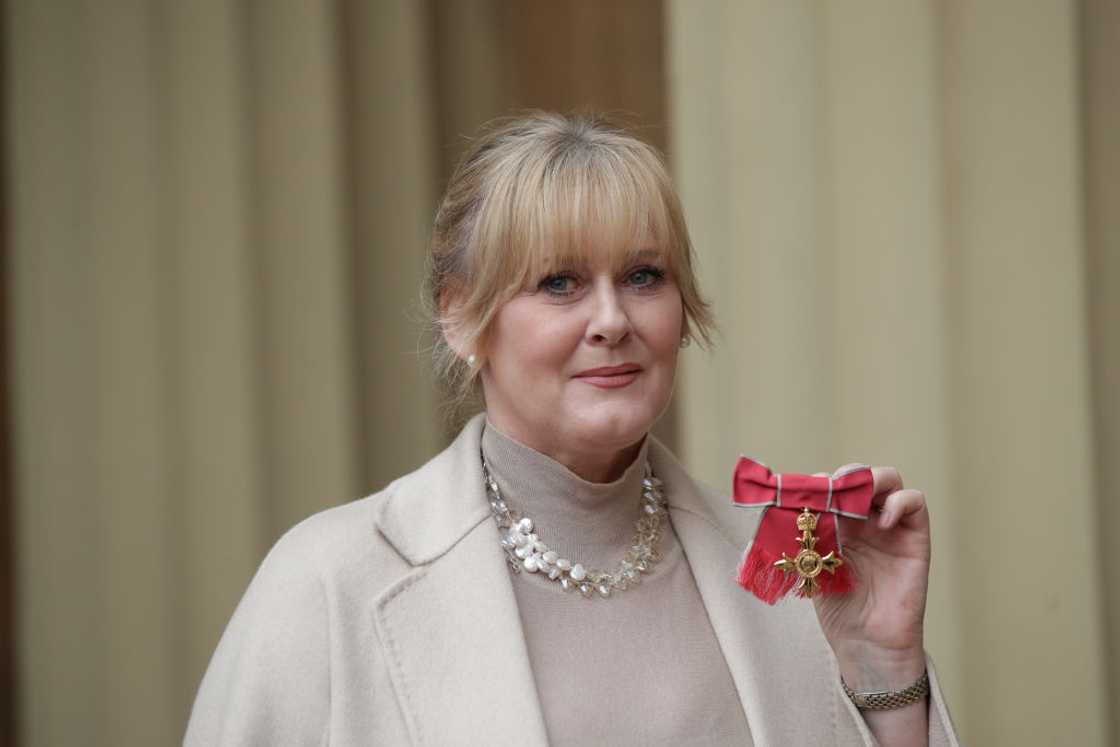 Actress Sarah Lancashire poses after she was awarded an OBE