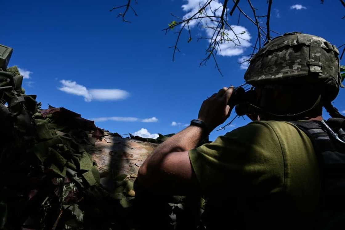 The trench in the Donbas region measures several dozen metres -- a labyrinth littered with pickaxes and underground shelters where the men sleep