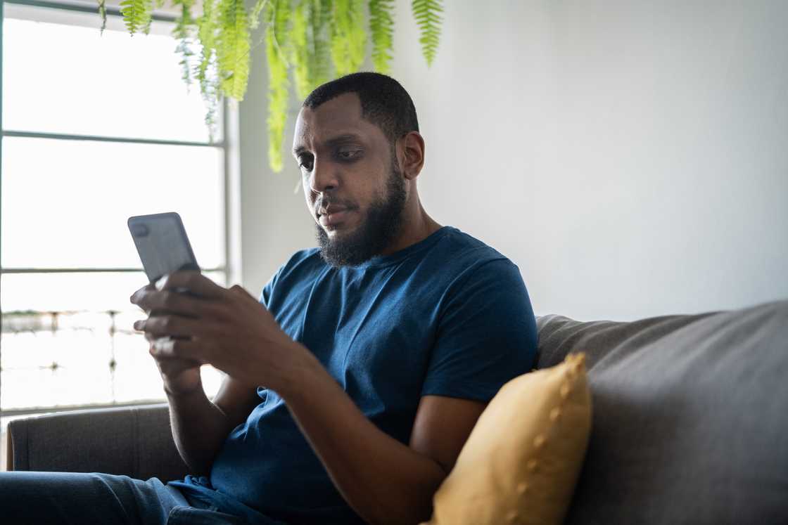 Man using a smartphone at home