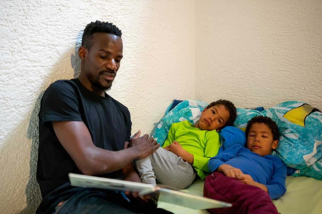 Father reading a story to his two kids