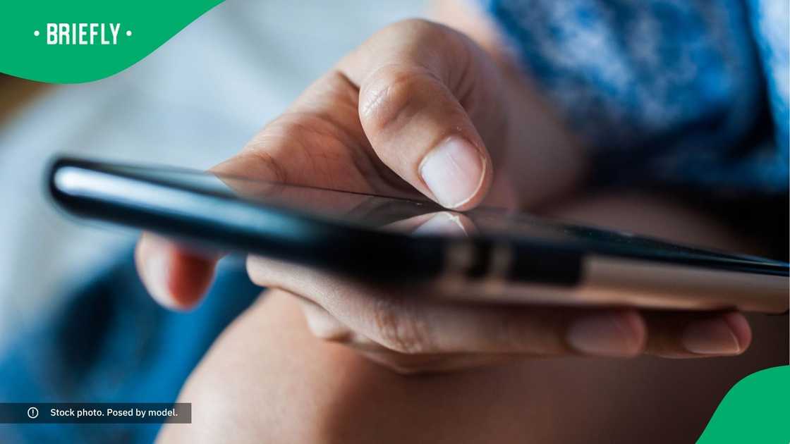 A woman typing on her phone. A woman typing on her phone.