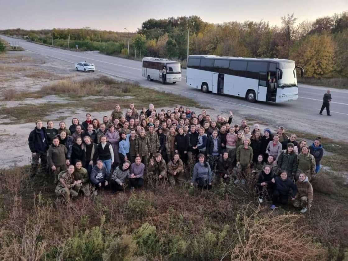 Freed Ukrainian female prisoners pose after their exchange in an unknown location in Ukraine following a swap with more than 100 Russian prisoners