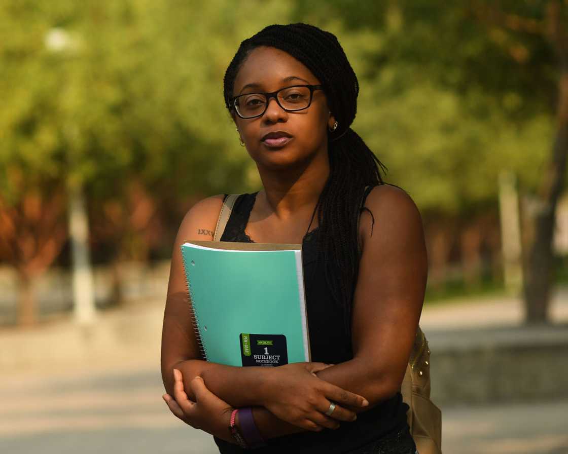 African student looking detached from academics outdoor