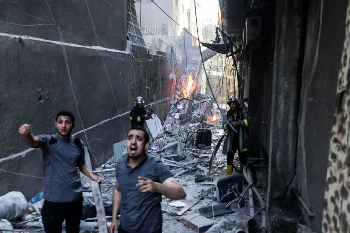 Palestinian firefighters battle a blaze sparked by an Israeli air strike on Gaza City Palestinian firefighters battle a blaze sparked by an Israeli air strike on Gaza City