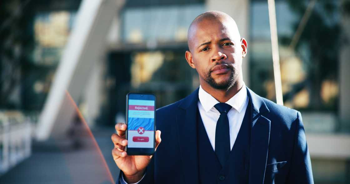 Outside a courthouse, a phone displays news of denied bail. Outside a courthouse, a phone displays news of denied bail.