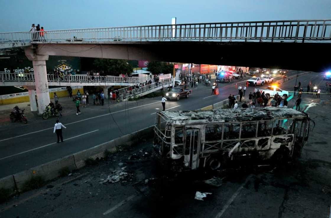 Police inspect an area where suspected gang members set a bus on fire in Mexico's western state of Jalisco Police inspect an area where suspected gang members set a bus on fire in Mexico's western state of Jalisco