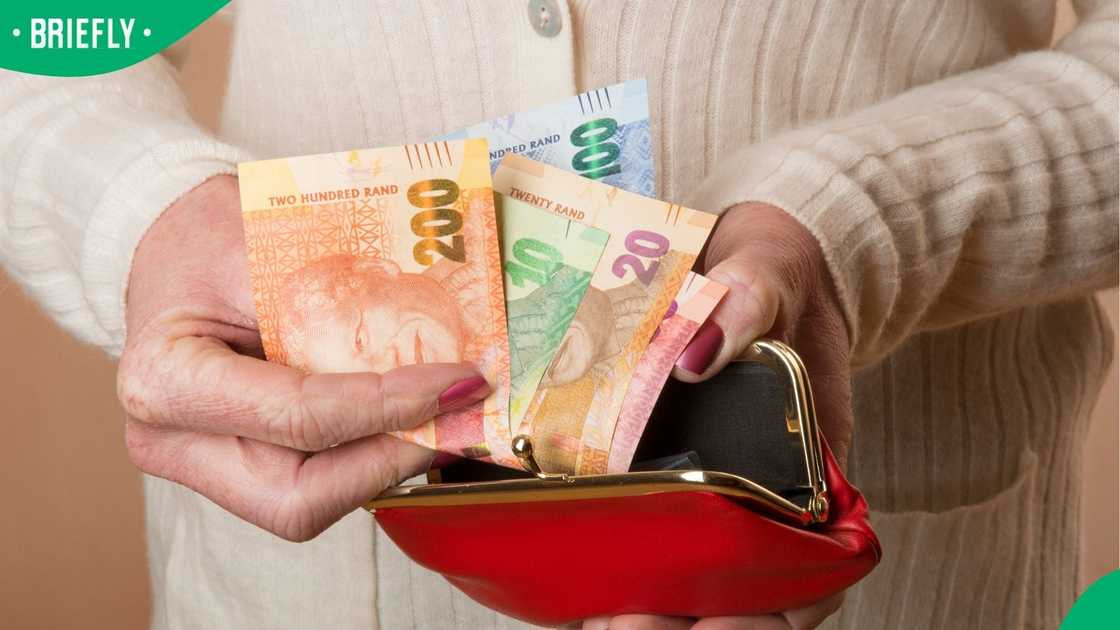 South African banknotes in a woman's hand