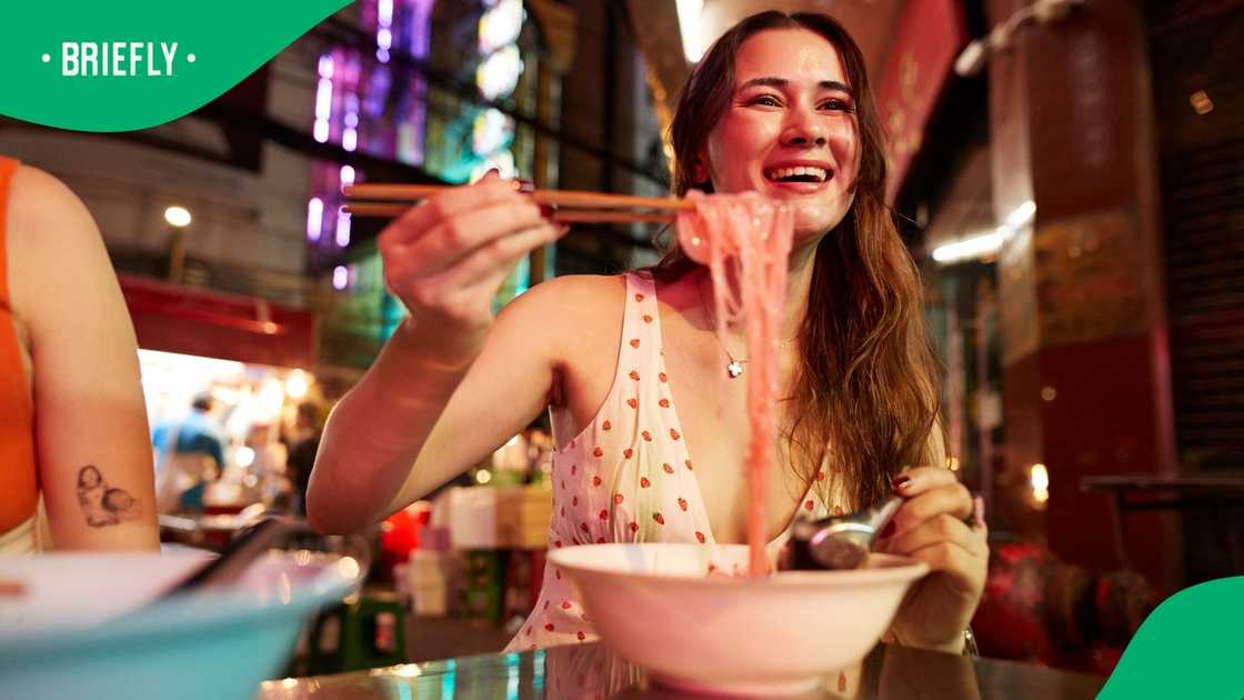 A person shows how to eat using chopsticks. A person shows how to eat using chopsticks.