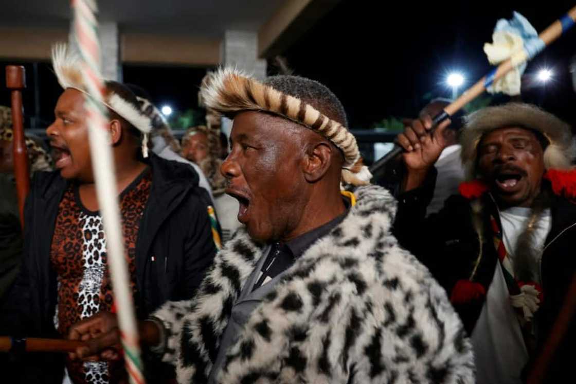 Amabutho (Zulu regiments) sing praises as they wiat for the new king to arrive Amabutho (Zulu regiments) sing praises as they wiat for the new king to arrive
