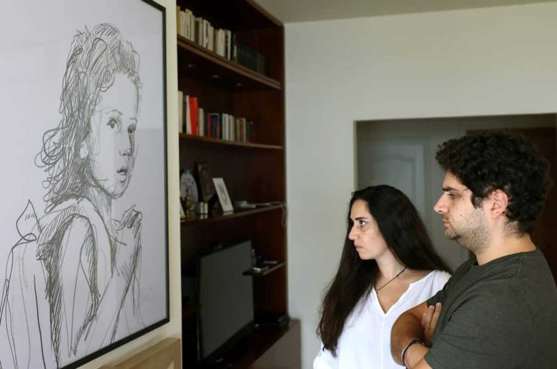Paul and Tracy Naggear lost their three-year-old daughter Alexandra in the port blast: here they look at a drawing of her Paul and Tracy Naggear lost their three-year-old daughter Alexandra in the port blast: here they look at a drawing of her