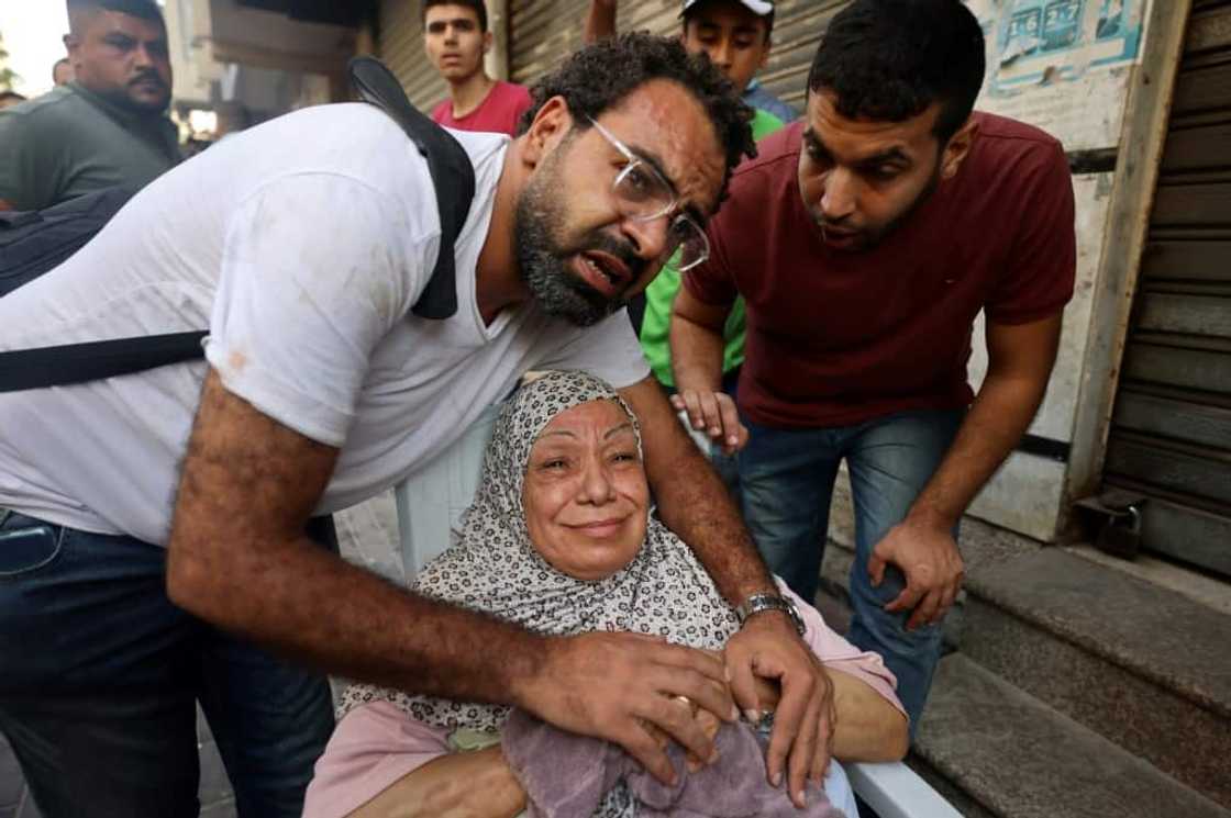 A relative comforts an injured Palestinian woman following an Israeli air strike on Gaza City A relative comforts an injured Palestinian woman following an Israeli air strike on Gaza City