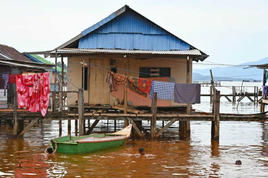 Children swim in polluted seawater in Pomalaa Children swim in polluted seawater in Pomalaa