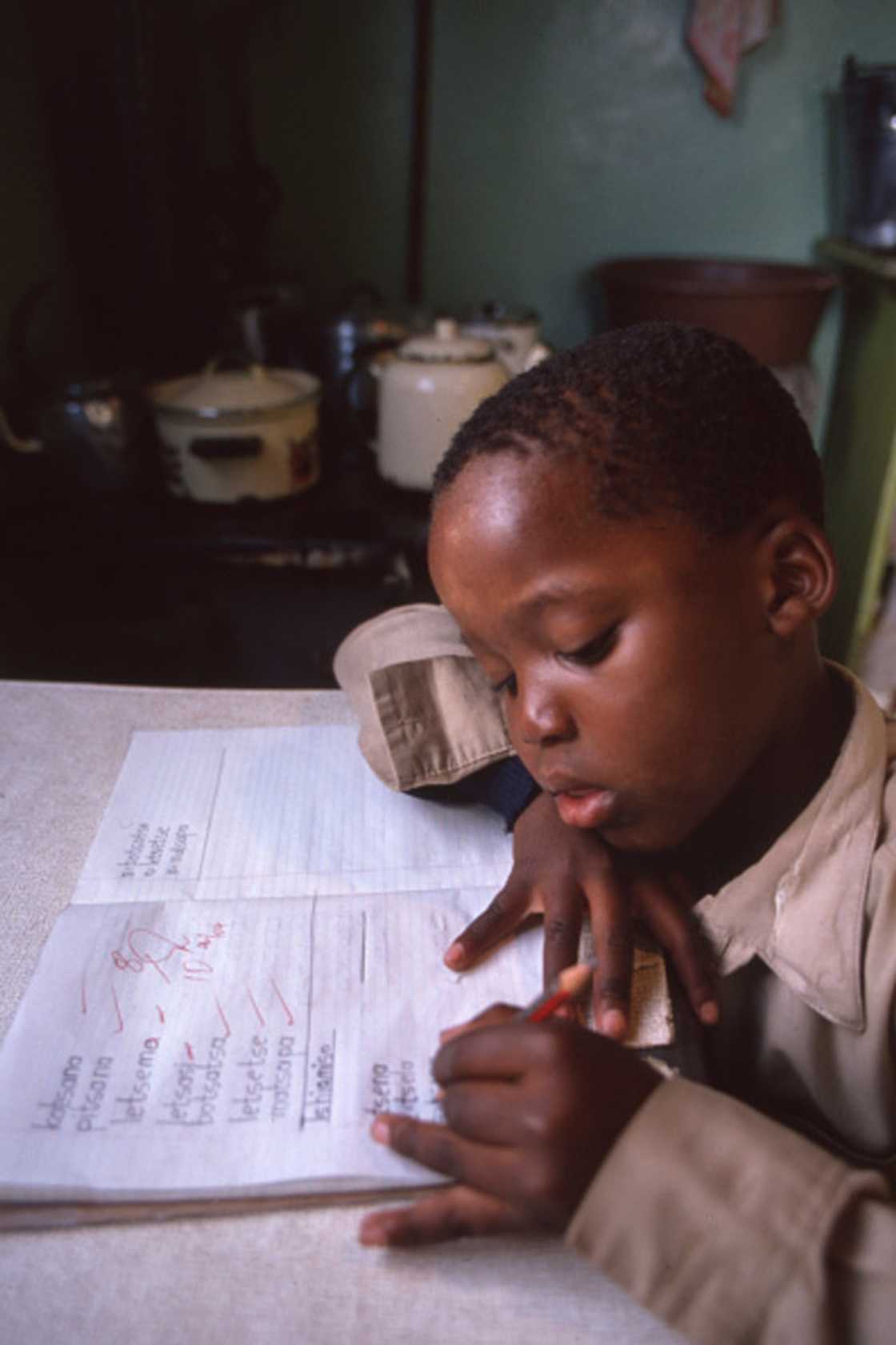 A little boy doing his homework, full of emotions left SA in their feelings.