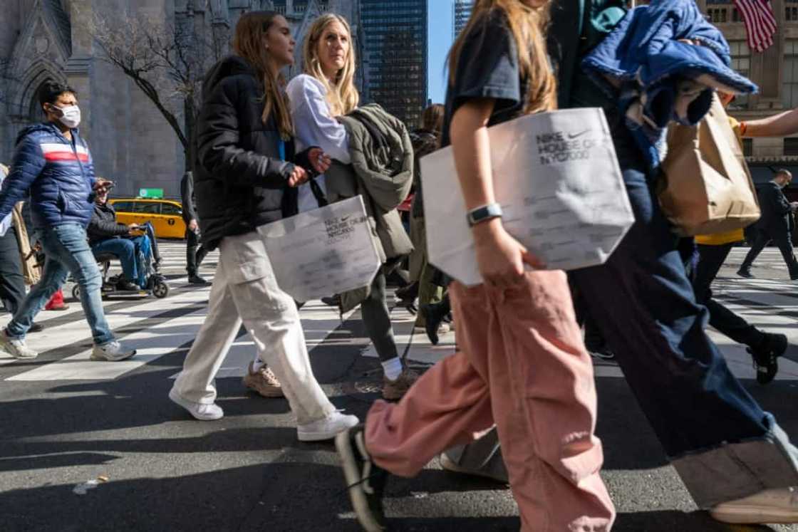 Pedestrians stroll along 5th Avenue in Manhattan, a premier shopping street in New York City Pedestrians stroll along 5th Avenue in Manhattan, a premier shopping street in New York City