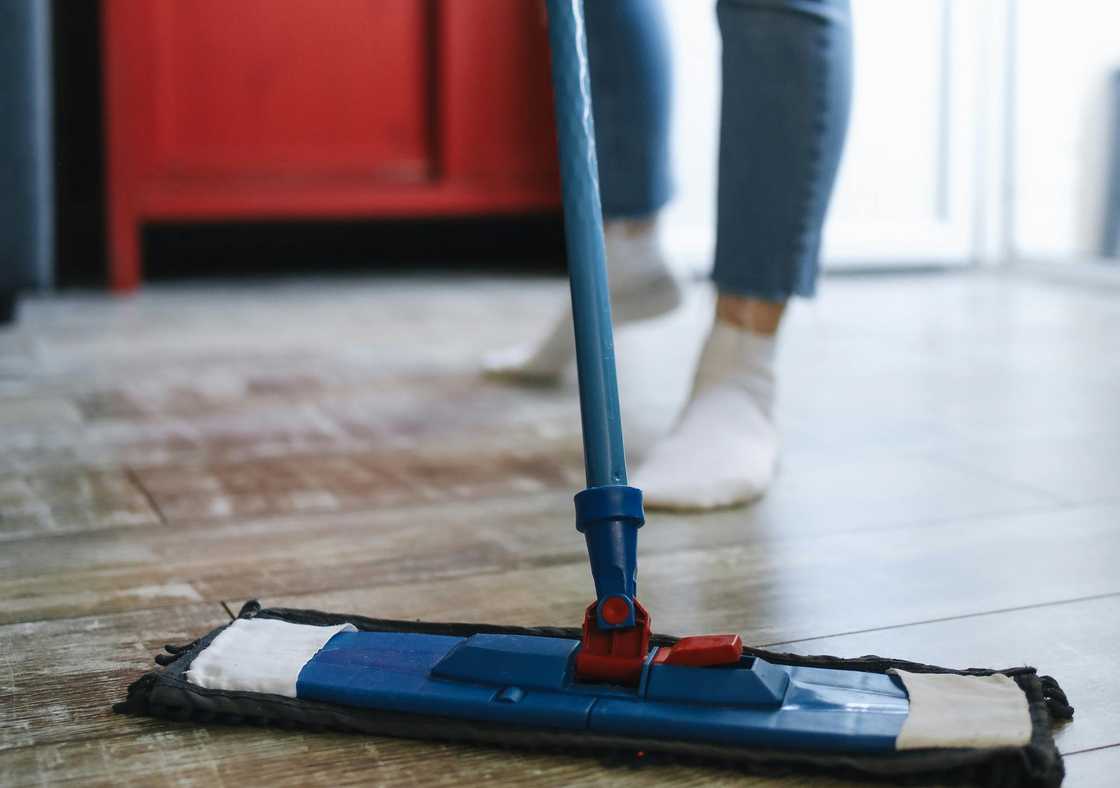 A woman mopping the floor A woman mopping the floor