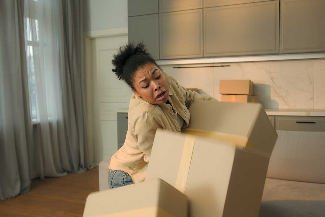 Angry black girl holds boxes Angry black girl holds boxes