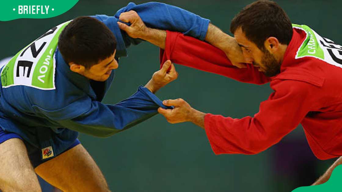 Islam Gasumov (blue) and Vakhtangi Chidrashvili (red) during the Men's Sambo Islam Gasumov (blue) and Vakhtangi Chidrashvili (red) during the Men's Sambo