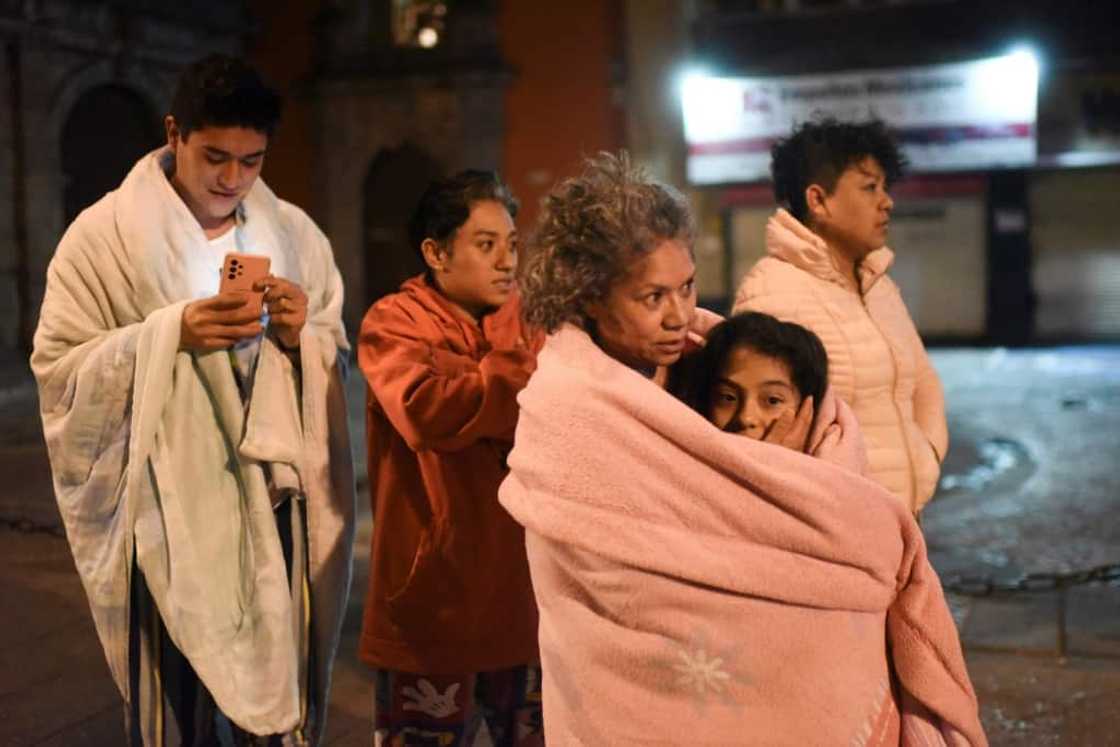 Residents wait in the street in Mexico City after a strong earthquake jolted the capital during the night Residents wait in the street in Mexico City after a strong earthquake jolted the capital during the night