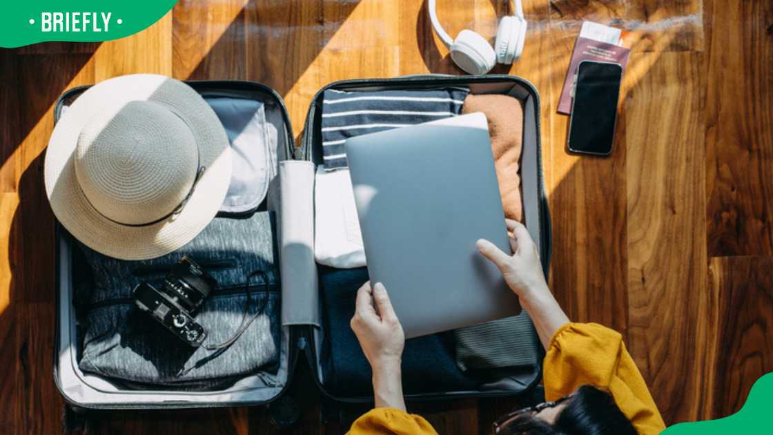 A woman packing a suitcase for a trip