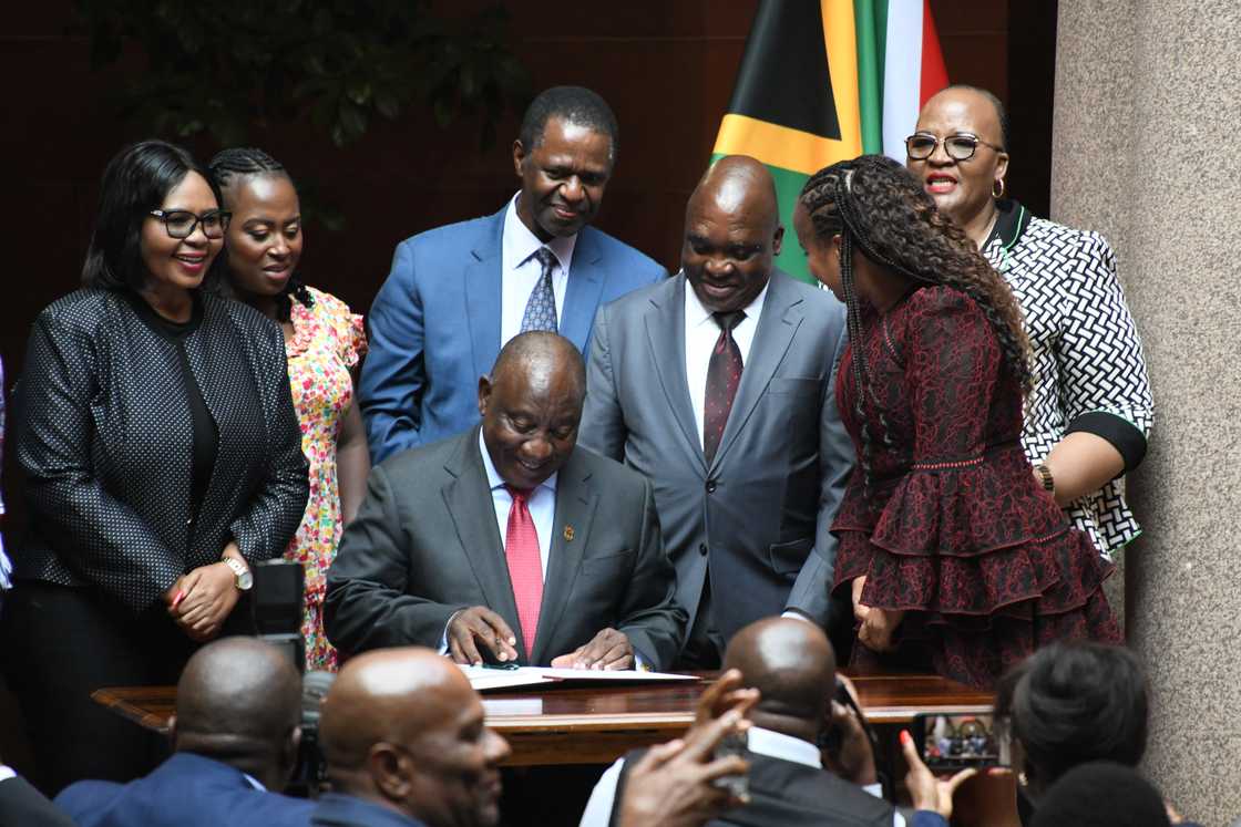 President Cyril Ramaphosa signing a bill into law President Cyril Ramaphosa signing a bill into law