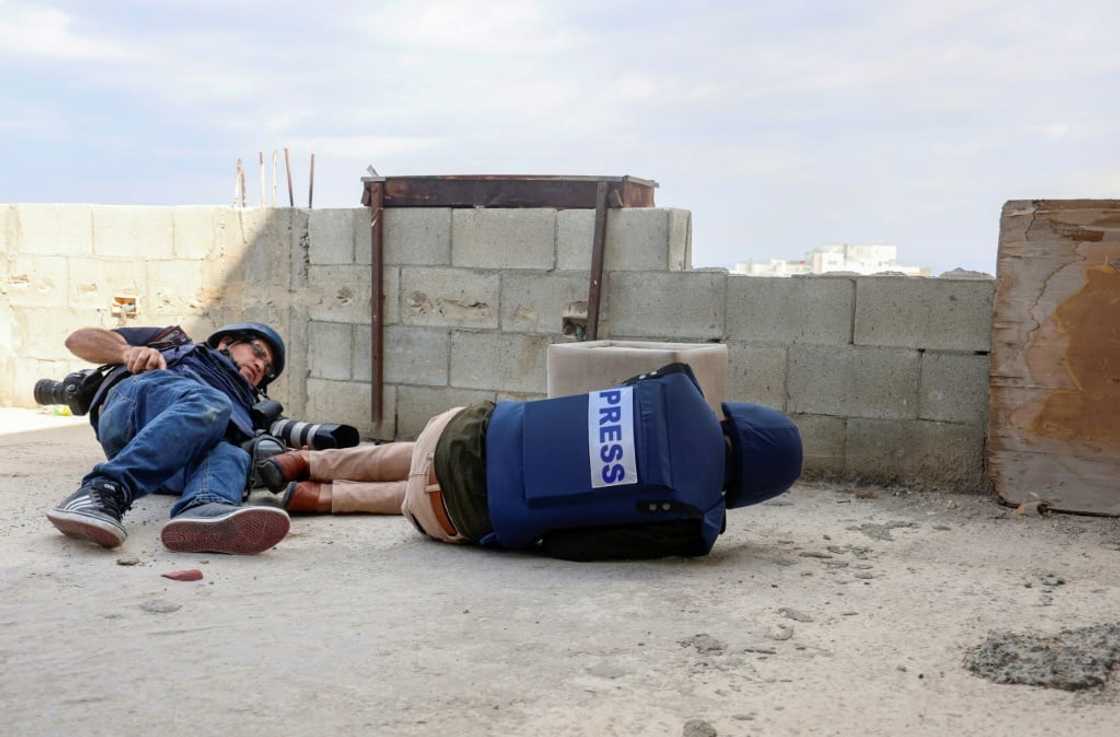 Journalists take cover during an operation by Israeli security forces in Jenin city in the occupied West Bank, after two reporters were wounded Wednesday Journalists take cover during an operation by Israeli security forces in Jenin city in the occupied West Bank, after two reporters were wounded Wednesday