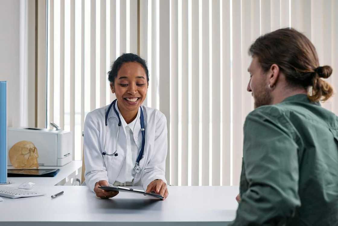 A young female doctor talking to a patient A young female doctor talking to a patient