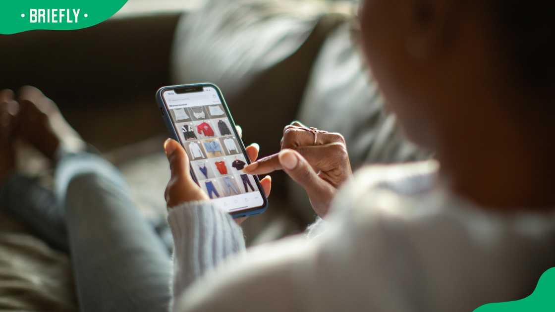 A woman purchasing clothes on a mobile app A woman purchasing clothes on a mobile app
