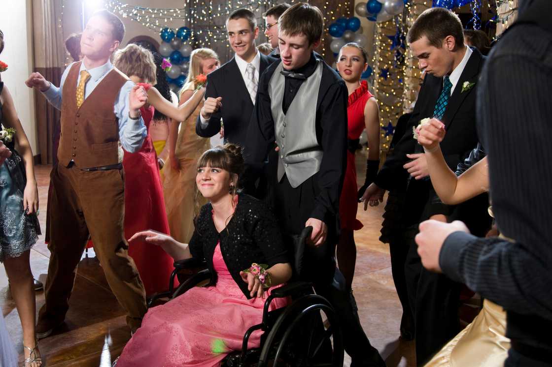 A disabled girl in a pink dress