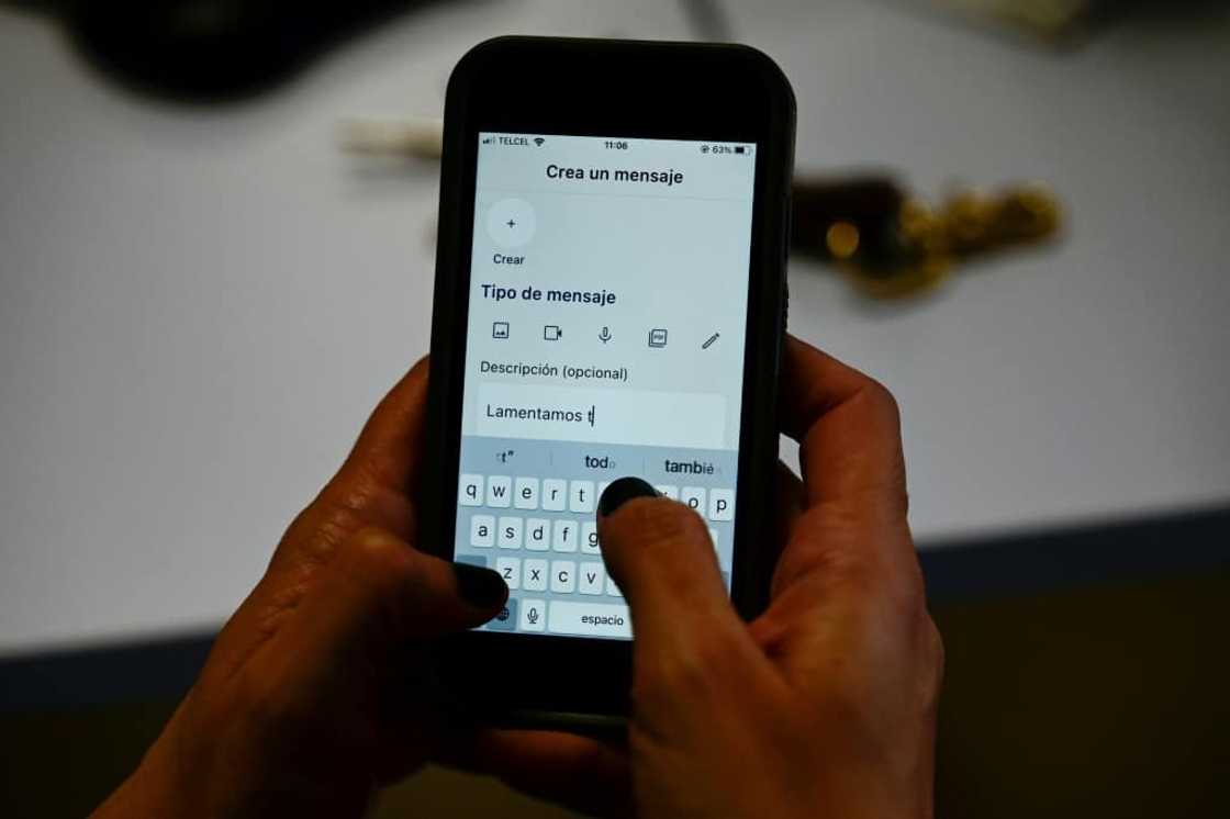 A woman types a message into Past Post, an application to store messages and last wishes to share after death A woman types a message into Past Post, an application to store messages and last wishes to share after death