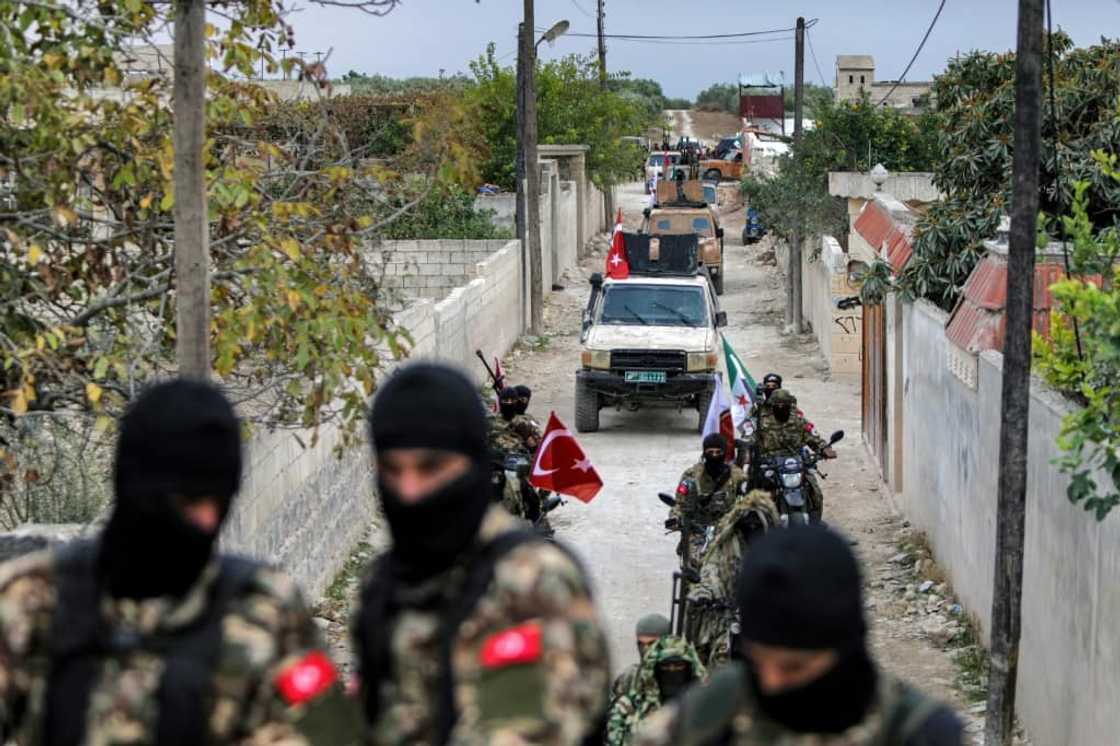 A convoy of Syrian fighters during a military drill by the Turkish-backed 'Suleiman Shah Division' in northern Syria on November 22