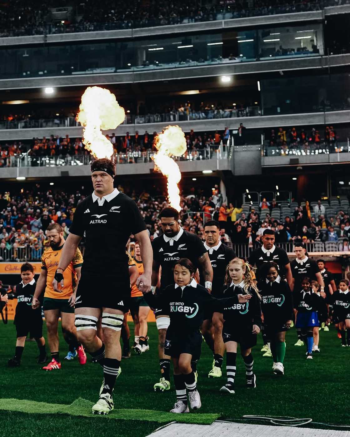 The All Blacks entering the pitch.