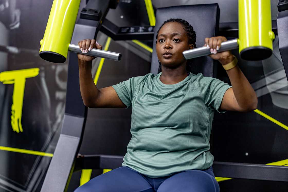 A focused woman is working out at the gym A focused woman is working out at the gym