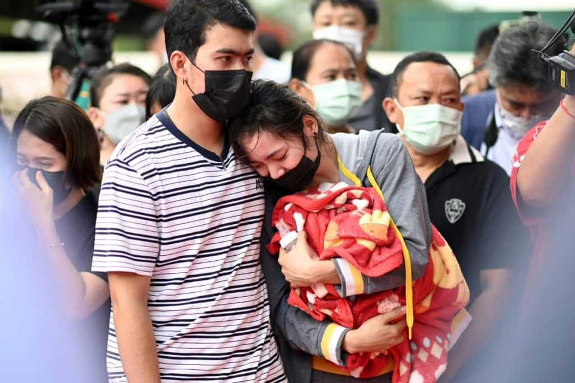 One mother wept inconsolably, hugging her dead son's favourite red-and-yellow blanket and his milk bottle, still half-full One mother wept inconsolably, hugging her dead son's favourite red-and-yellow blanket and his milk bottle, still half-full