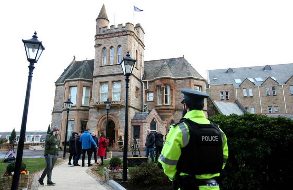 Journalists gather outside the Culloden Hotel near Belfast