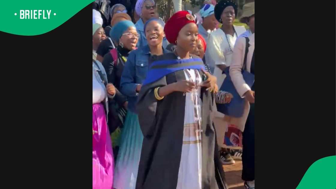 A woman in her graduation attire. A woman in her graduation attire.