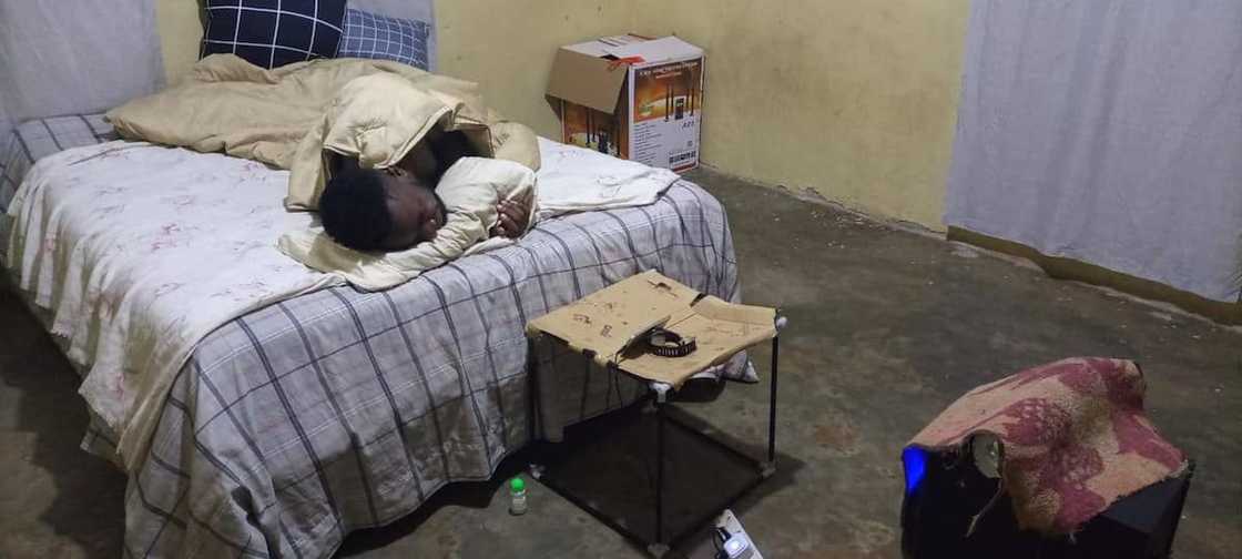 Home makeover before photo of sickly man lying in bed Home makeover before photo of sickly man lying in bed