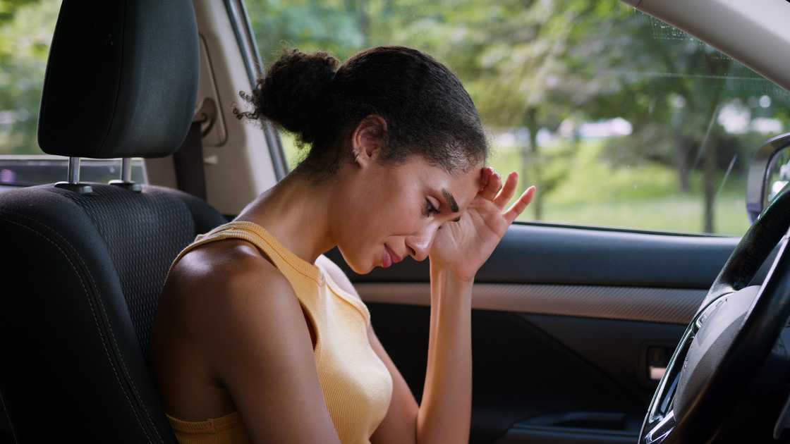 A depressed woman crying in a car A depressed woman crying in a car