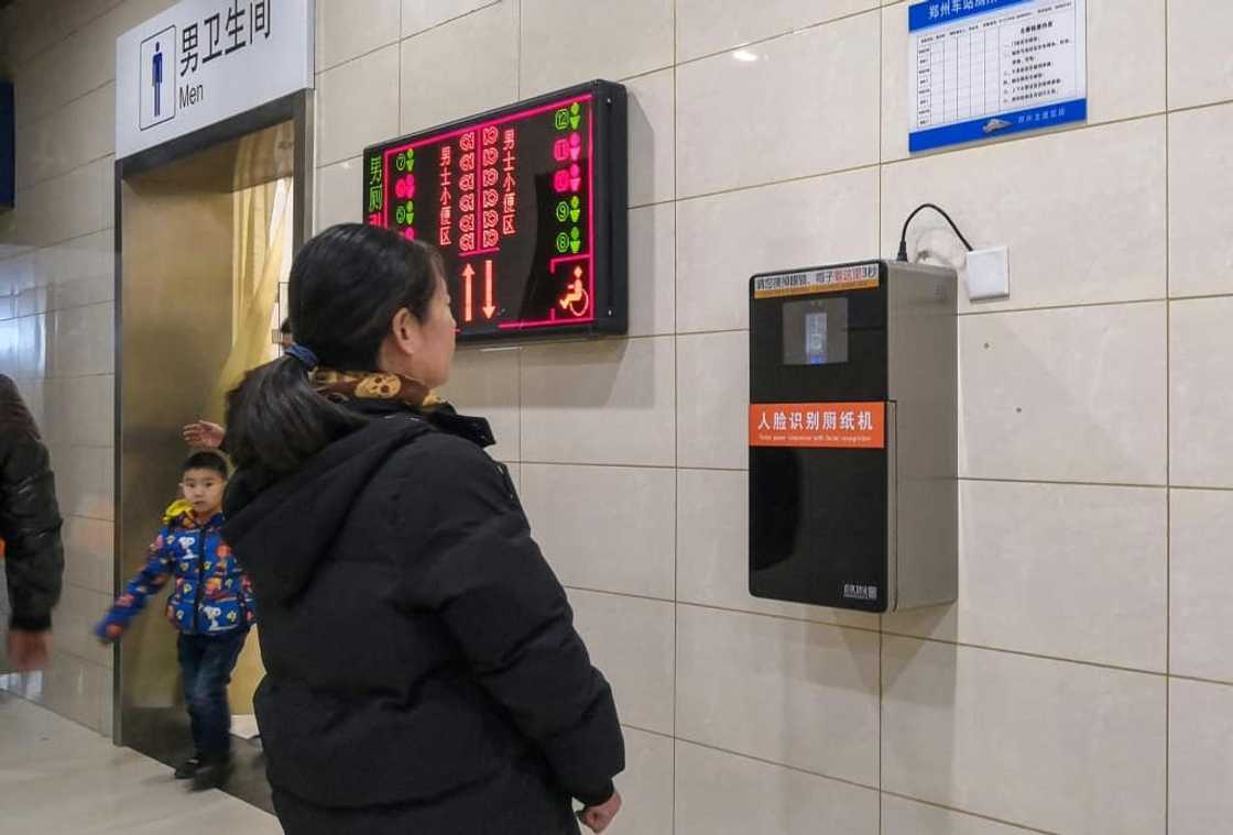 An automatic toilet paper dispenser (R) at a Chinese railway station uses facial recognition technology. China is drafting rules on use of the technology An automatic toilet paper dispenser (R) at a Chinese railway station uses facial recognition technology. China is drafting rules on use of the technology