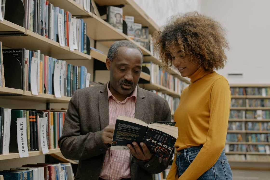 A student and a teacher in the library