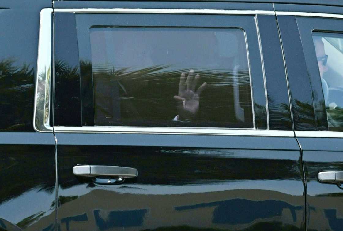 Former president Donald Trump waves as he rides in the back of an SUV to the airport in Palm Beach Former president Donald Trump waves as he rides in the back of an SUV to the airport in Palm Beach