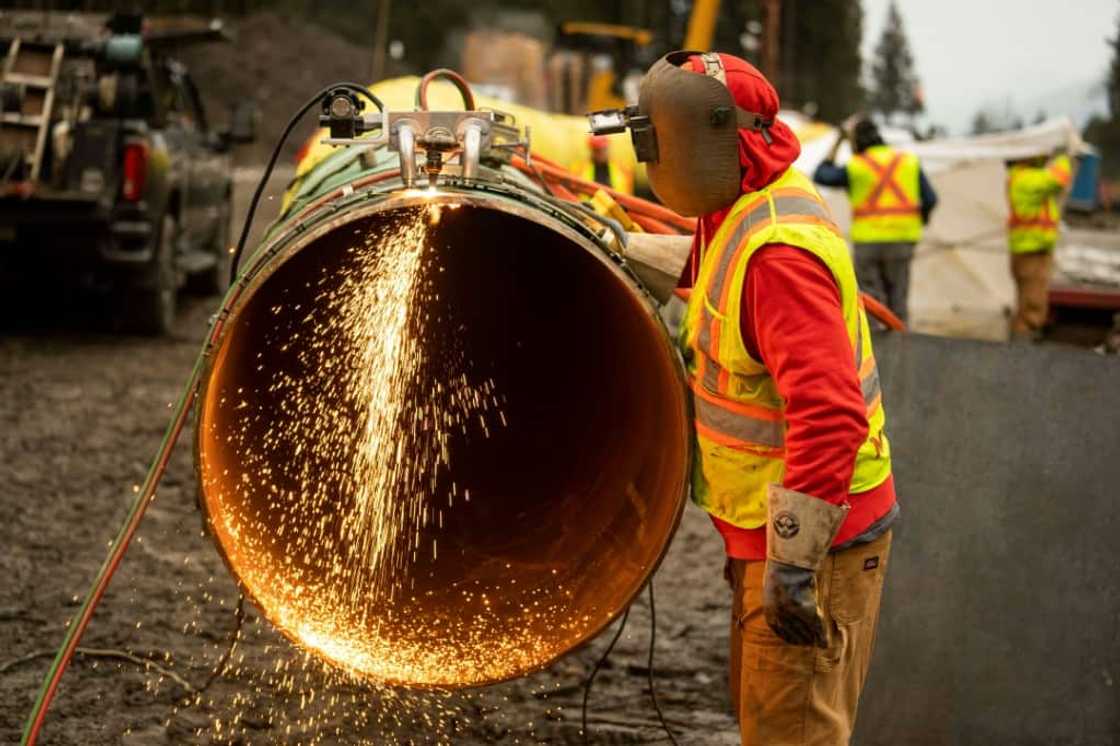 This January 17, 2023, image courtesy of Trans Mountain Corporation shows a welder working on a pipeline in Bridal Falls, British Columbia, Canada. The pipeline will carry 600,000 additional barrels per day of oil from Alberta to Canada's Pacific coast for shipping overseas This January 17, 2023, image courtesy of Trans Mountain Corporation shows a welder working on a pipeline in Bridal Falls, British Columbia, Canada. The pipeline will carry 600,000 additional barrels per day of oil from Alberta to Canada's Pacific coast for shipping overseas