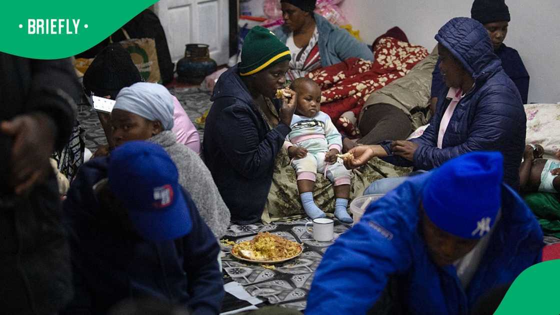Immigrants share a meal as they take refuge in a mosque in Gansbaai, about 140km from Cape Town, on June 2, 2026, after they were threatened in the communities in which they live